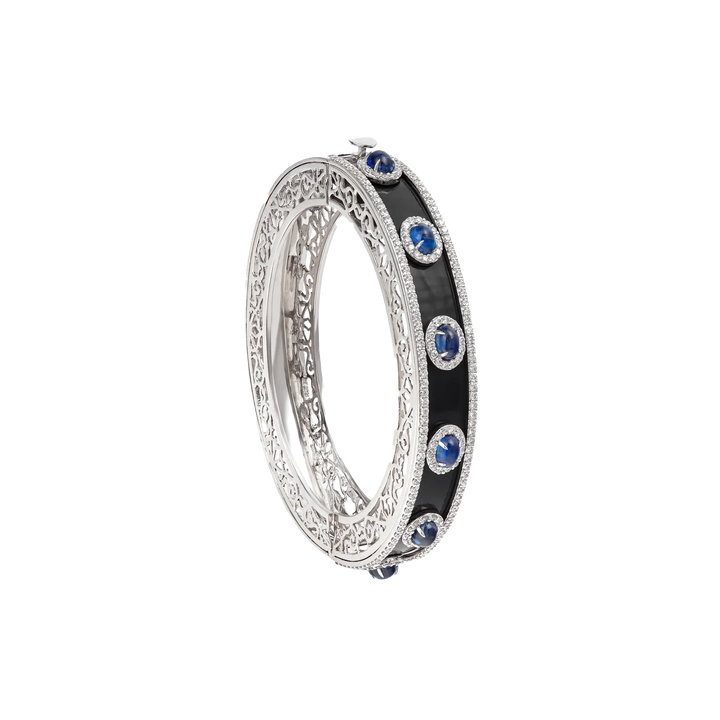 Bangle in 18K white gold with VS-G diamonds, black enamel, and blue topaz stones