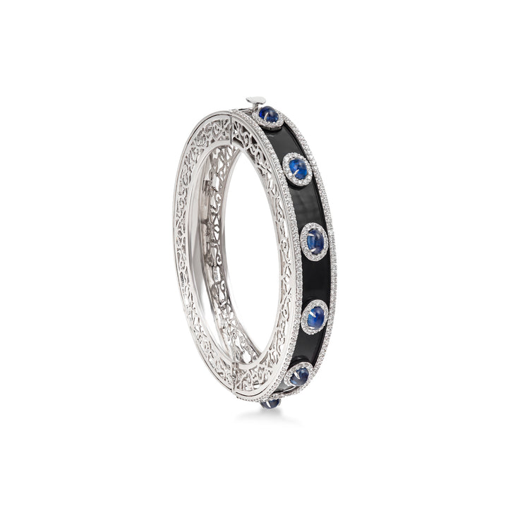 Bangle in 18K white gold with VS-G diamonds, black enamel, and blue topaz stones